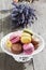 Colorful macaroons on bowl and lavender