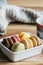 Colorful macaroons in a box on a wooden background