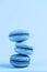 Colorful macaroons on a classic blue background, close-up, Flatley with copy space