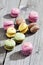 Colorful macaroons on gray wood