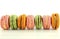 Colorful macaroons on white wood table