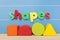 Colorful magnetic letter spelling shapes.