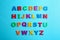 Colorful magnetic letters on blue background. Alphabetical order