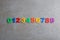 Colorful magnetic numbers on grey stone background