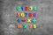 Colorful magnetic numbers and math symbols on stone background, flat lay