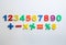 Colorful magnetic numbers and math symbols on white background