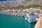 Colorful Makarska boats and waterfront under Biokovo mountain vi