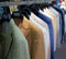 Colorful male suits in row in a hanger