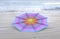 Colorful Mandalas on wood for anti-stress therapy and yoga on sand with sea view coast 3d illustration