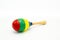 A colorful maracas lying on a white underground