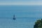 Colorful marine landscape with sail boat against deep blue sea