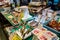 Colorful market stall with seafood, oysters, snails, fried fish and other seafood snacks in traditional Nishiki Market in Kyoto.