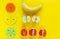 Colorful math fractions and apples, oranges, banana as a sample on yellow background or table. Interesting fun math for kids.
