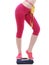 Colorful measuring tape on woman body, fit girl measuring her waistline standing on scale