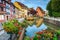 Colorful medieval half-timbered facades reflecting in water,Colmar,France