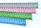 Colorful Metal Rulers on White Tabletop