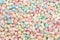 Colorful mini marshmallows in pastel colours background texture