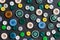 Colorful mixed sewing buttons on black background, flat lay
