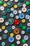 Colorful mixed sewing buttons on black background, flat lay. Top view