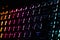 Colorful modern keyboard with rainbow backlight on black background. Backlight of the keyboard in different colors
