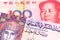 Colorful money from Hong Kong with a red Chinese yuan note