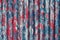 colorful motley peeled off red and blue paint layers on corrugated zinc coated steel sheet texture