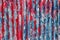 colorful motley peeled off red and blue paint layers on corrugated zinc coated steel sheet texture