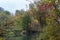 Colorful, multi-color leaves of trees in a river reflection. Early autumn morning on the Kazanka River in Kazan