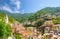 Colorful multicolored buildings houses on green hill in valley of Riomaggiore traditional typical Italian fishing village in Natio