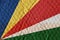 Colorful multicolored flag of Republic of Seychelles on an uneve