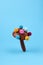 Colorful mushroom made of pom pom on blue background