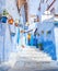 Colorful narrow old street in medina at sunny morning , Chefchaouen, Morocco