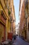 Colorful narrow street with restaurant in Nice, France. Cote d`azur