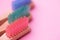 Colorful natural bamboo brushes on pink background