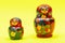 Colorful Nesting wooden Dolls isolated on bright yellow. National Russian souvenirs. Babushkas or Matryoshkas.