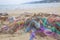 Colorful nets on beach. Trash in nature. Ecology crisis concept