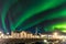 Colorful northern lights Aurora borealis with a warehouse in the foreground in Iceland