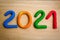 Colorful numbers 2021 on wooden background