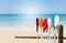 Colorful oars over fine sandy beach with clear blue sky background