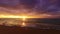 Colorful ocean beach sunrise with dramatic cloudscape and sun rays, 4k video