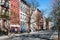 Colorful old buildings line the empty sidewalks along 10th Street in New York City