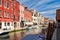 Colorful old houses next to the canal at the island of Murano