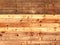 Colorful old rustic wooden plank wall or floor with rich brown colored boards made of reused timber