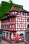 Colorful old wooden building in Lucerne Switzerland with exposed red wood overcast day