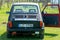 Colorful oldtimer PanCars rental car Fiat 126 parked on the lawn