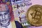 Colorful one Omani rial bank note with golden bitcoin