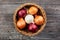 colorful onions basket on wood