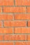 Colorful orange brick wall background in a Flemish stretcher bond pattern.Wide brick wall panoramic texture. Home and