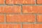 Colorful orange brick wall background in a Flemish stretcher bond pattern.Wide brick wall panoramic texture. Home and