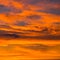 Colorful orange cloudscape in  evening dawn sky at sunset
